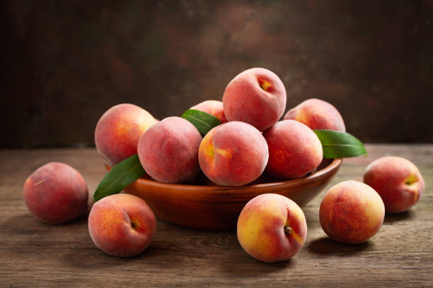 istock fresh peaches with leaves in a bowl 1156301429
