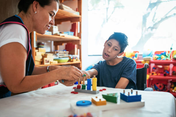 istock Boy with Celebral Palsy learning shapes and colors 1156301474