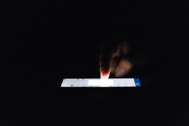 istock Woman using her mobile phone, city skyline night light background 1156301581