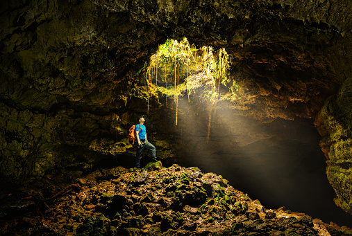 Cave in the Azores with backpacker