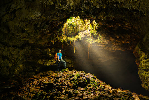Cave in the Azores with backpacker Cave in the Azores with backpacker volcano photos stock pictures, royalty-free photos & images