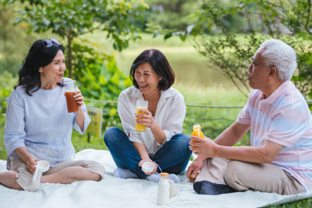 istock Three Asia Senior Retirement Having Picnic In Park Concept 1156301665