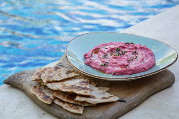 istock Beetroot hummus with pieces of freshly baked naan bread 1156301675
