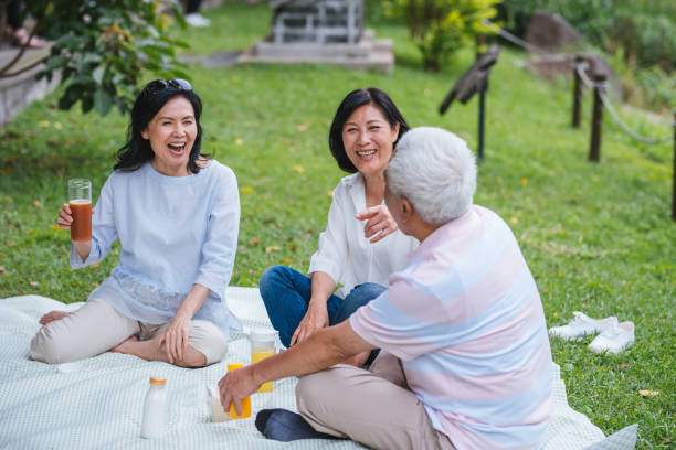 istock Three Asia Senior Retirement Having Picnic In Park Concept 1156301678