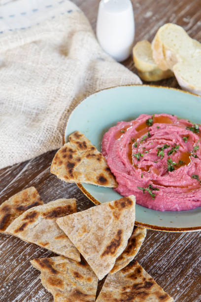 istock Beetroot hummus with pieces of freshly baked naan bread 1156301694
