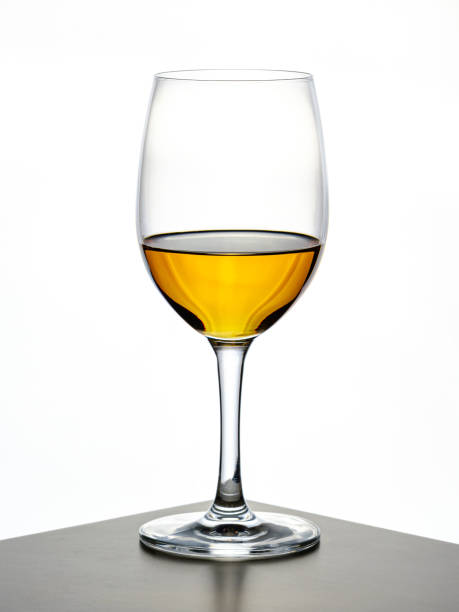 istock transparent wine glass with cognac being poured in 1156301958