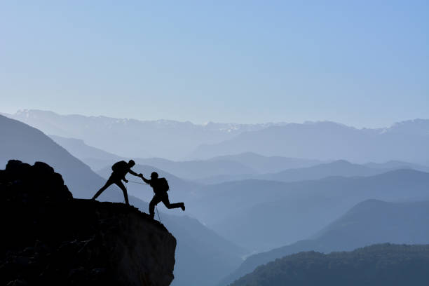 istock mountaineers' determined struggle, success and spectacular mountain ranges 1156304984