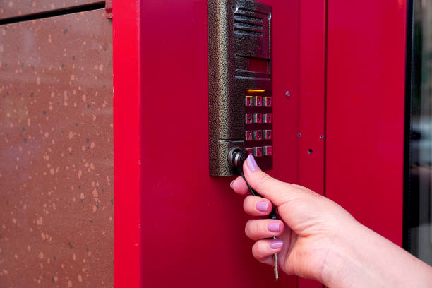 istock Female hand opens electronic lock with chip key. Keyboard security system with a key opens the office and the apartment. 1156307070