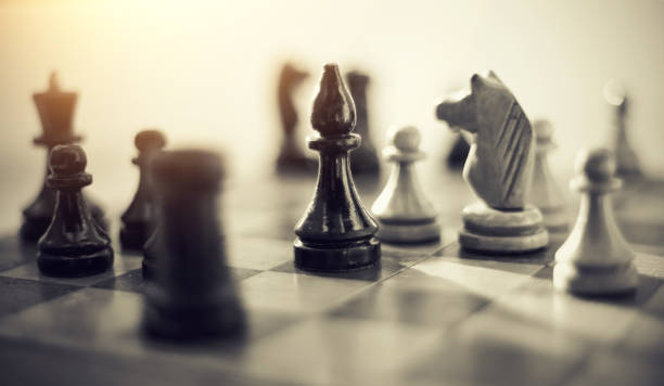 istock Wooden chess pieces on the chessboard. 1156308938