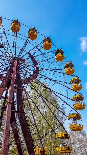 Abandoned Pripyat amusement park. Due to the Chernobyl nuclear explosion it was never open. A close up on a big marry-goes-round, ferry wheel. Abandoned lunapark.