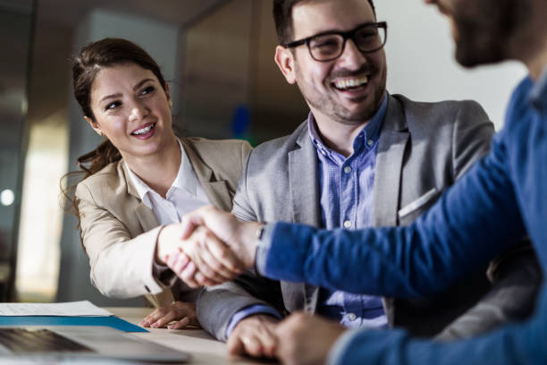istock Happy business colleagues shaking hands in the office. 1156309622