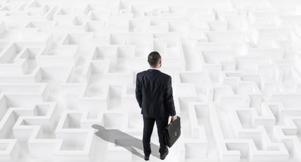 istock Businessman on a white large maze or labyrinth.Strategy Concept. 1156309636