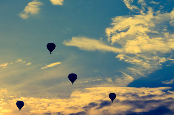 istock Four hot air balloons walking on the sky 1156309956