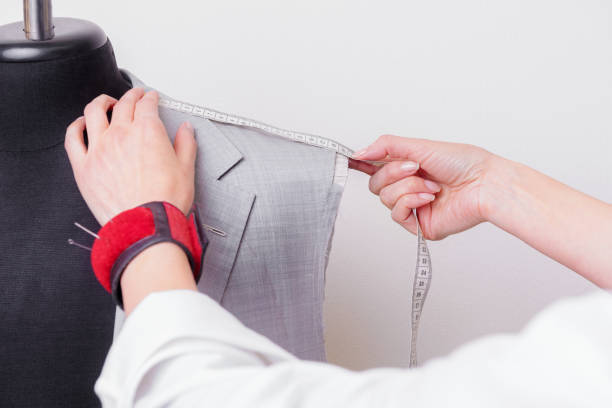istock Female tailor hands at work with half-finished suit 1156314728