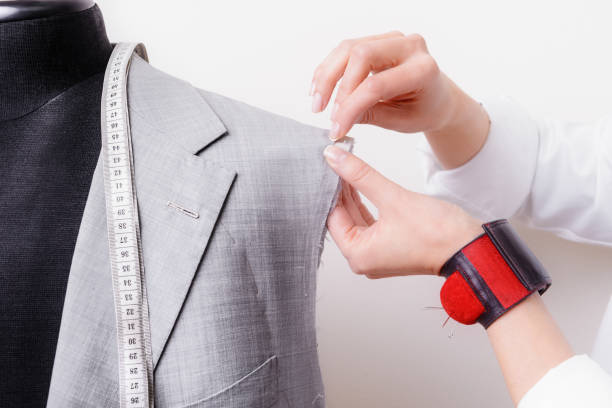 istock Female tailor hands are working with half-finished suit 1156314750