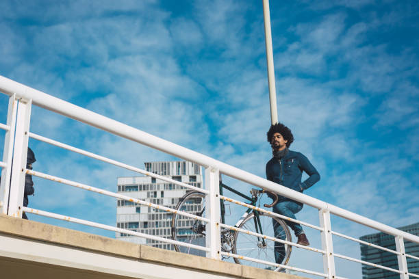 istock Man with afro hair riding a vintage style bicycle 1156316663
