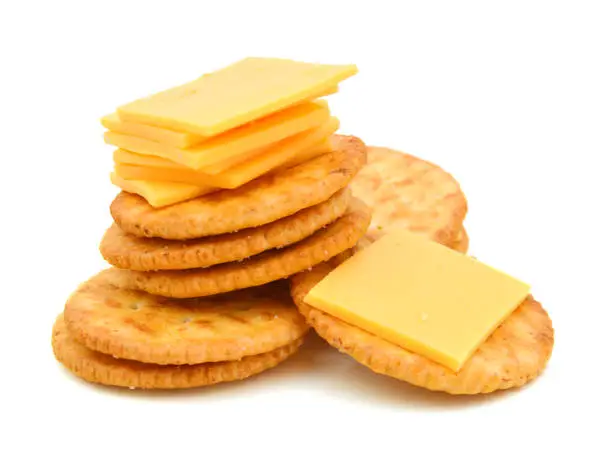 Photo of Crackers with cheese on white background