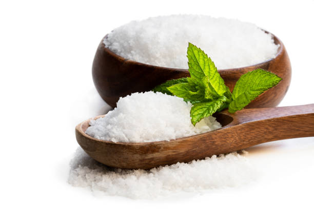 istock Wooden spoon with sea salt isolated on white 1156322176