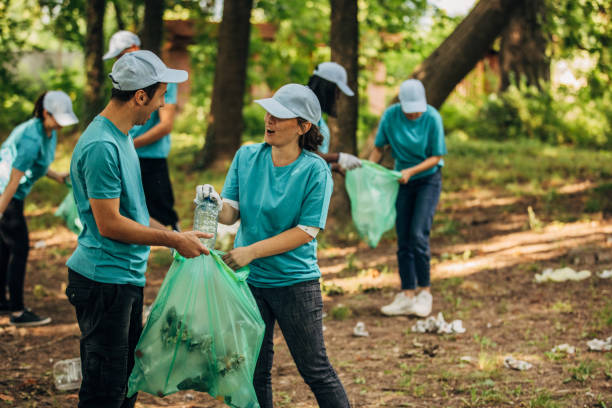 istock Group of young volunteers picking garbage 1156322741