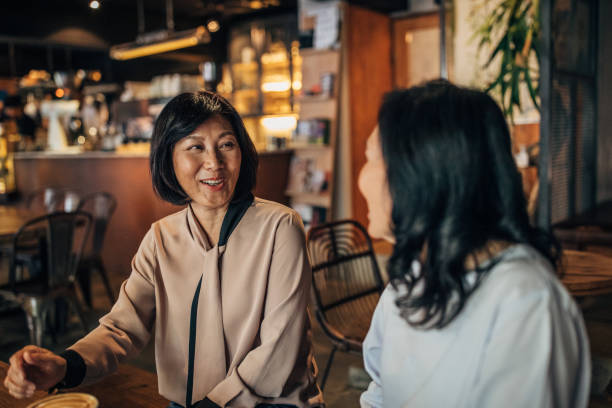 istock Senior female friends talking over coffee 1156323849