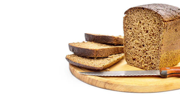 istock Sliced rye bread with knife on cutting board. Isolated on white. 1156324109