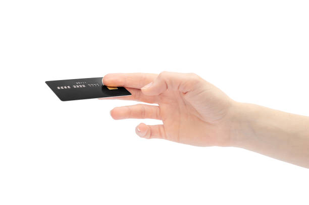 istock Woman's hand holding credit card. Isolated on white. 1156324171