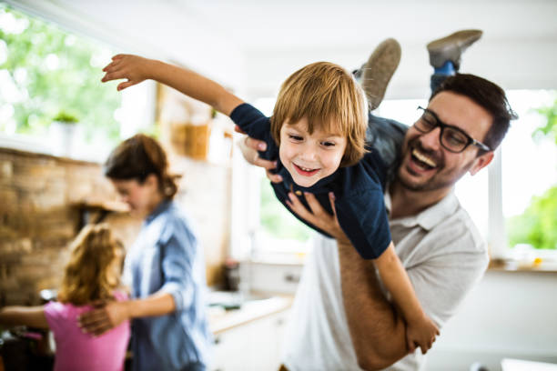 istock Happy boy having fun with his father in the kitchen. 1156324381