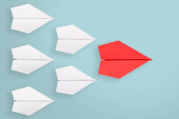 istock Leadership concepts with blue paper airplane leading among white 1156325451