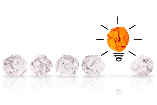 istock Idea Concepts Light Bulb Crumpled Orange Paper on White Background 1156325536