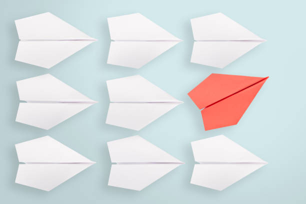 istock Change concepts with yellow paper airplane leading among white 1156326296