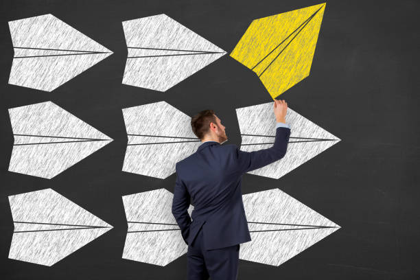 istock Going Your Own Way with Airplanes on Blackboard Background 1156326348