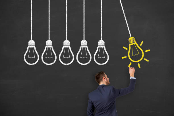 istock Idea concepts with light bulbs on a chalkboard background 1156326735