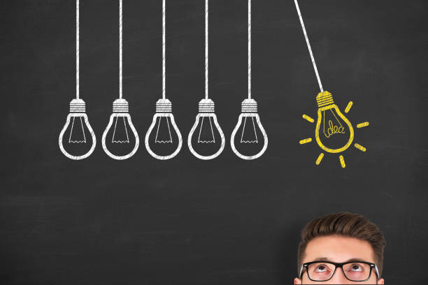 istock New idea concepts with light bulbs on a chalkboard background 1156326802