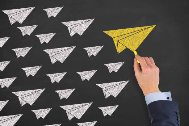 istock Leadership Concepts with Airplanes on Chalkboard Background 1156328008