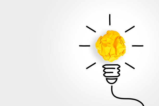 istock New Idea Concepts Light Bulb Crumpled Yellow Paper on White Background 1156328694