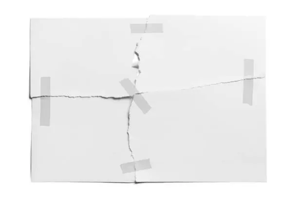 Torn sheet of paper glued with adhesive tape, isolated on white background