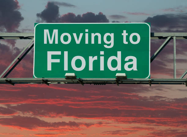 Moving to Florida Sign A road sign that says "Moving to Florida." cocoa beach photos stock pictures, royalty-free photos & images