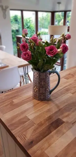 Flowers in a jug, a kitchen as a background