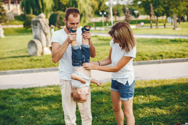 istock Family with son playing in a summer park 1156336611