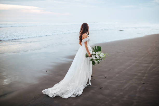 istock Bride on a beach in the blue water 1156337429