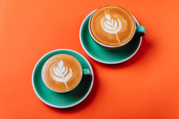 istock Cyan coffee cups over orange background. 1156337482