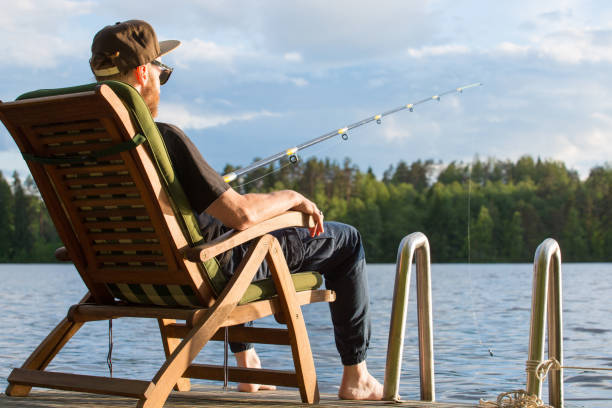istock Mature man fishing from pier 1156338550