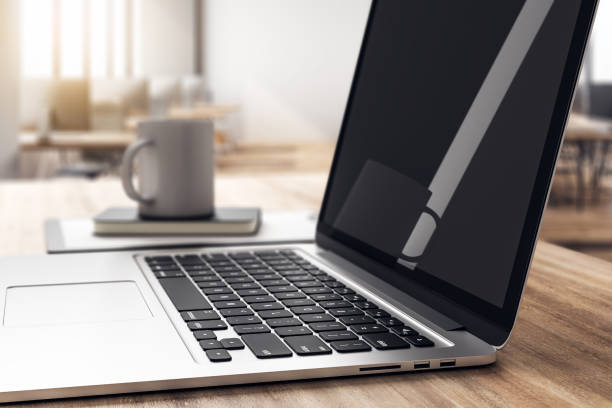 istock Wooden desktop with laptop side 1156338828