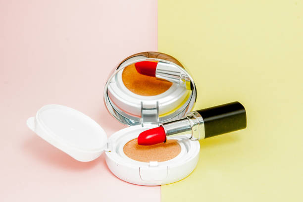 istock Make up products spilling on to a bright yellow and pink background with copy space 1156338869