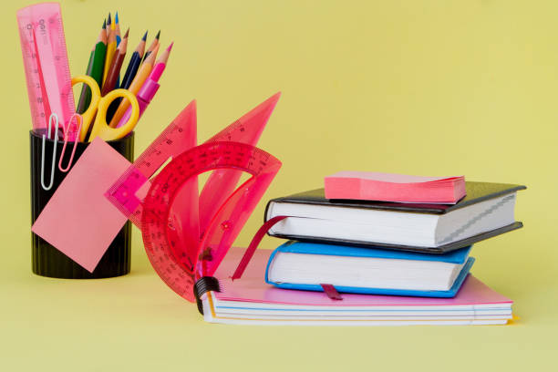 istock Back to school concept with space for text. Copy space. School office supplies.Creative desk with colourful stationery. Colored paper clip.School supplies on yellow background.Office desk 1156339625