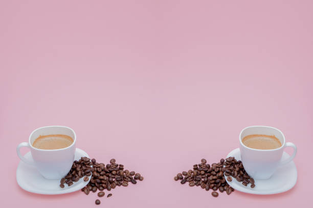 istock grains of roasted coffee scattered from a cup on a pink background, copy space 1156339735