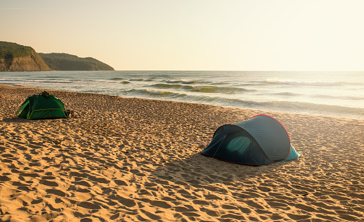 A small tent on a sandy beach