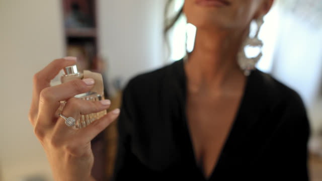 Young Woman Applying Perfume