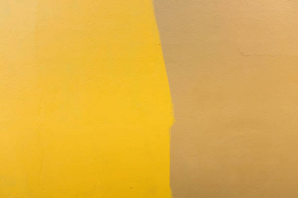 Full frame view of yellow and brown painted concrete wall - background concept
