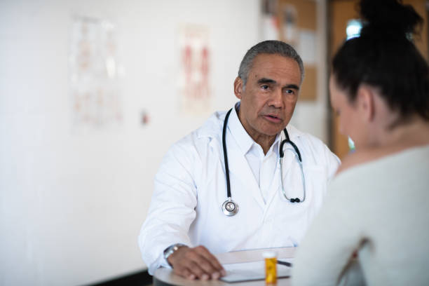 istock Male doctor talking to his patient 1156350145